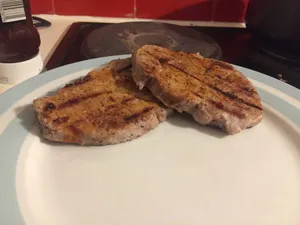 Some saucy pork shoulders on a plate.